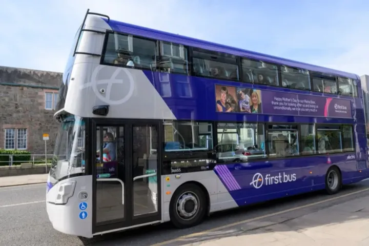 A purple and white First Bus electric double-decker bus.