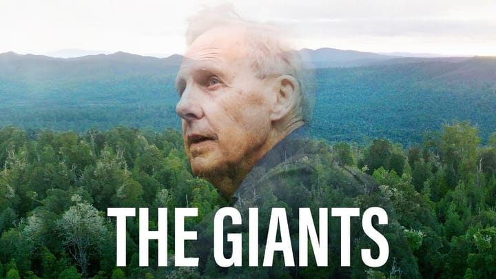 Poster for the documentary "The Giants," with Bob Brown's face blended in double-exposure into aerial views of dense green forest and forested hills. Title in white capitals at the bottom.